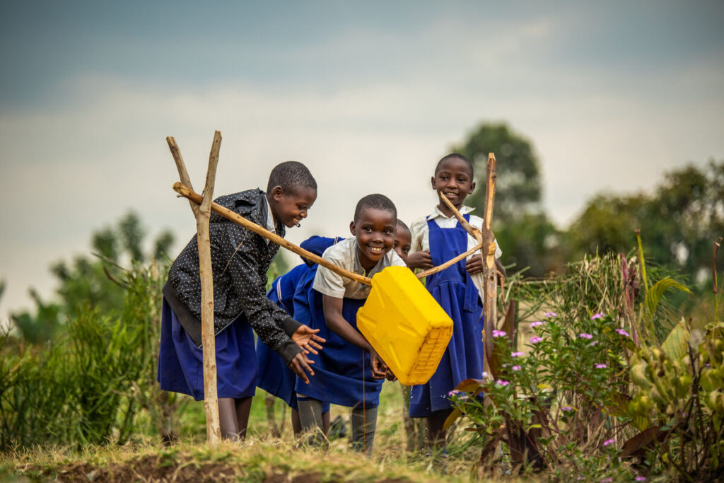/wp-content/uploads/2025/03/Members-of-the-Sanitation-Club-of-St.-Peter-and-Paul-Primary-School-demonstrating-how-a-tippy-tap-works_Amref-Health-Africa_Ambrose-Watanda-1024x683.jpg